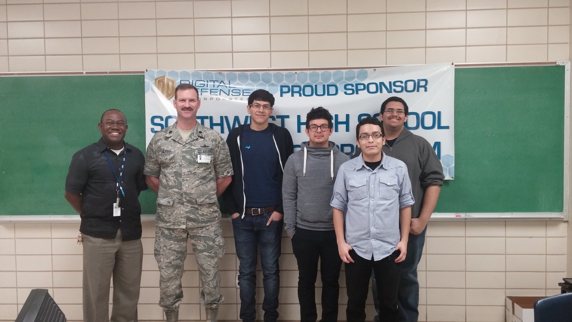 Lt. Col. Jim Burleigh, Cyber Mission Forces Planner for 24th Air Force, met with Mr. Arthur Celestin (left), coach of the Southwest High School CyberPatriot team, and team members from Southwest High School in San Antonio Jan. 15.  Southwest High School was one of 50 teams nationally to make the CyberPatriot semi finals.  (U.S. Air Force photo/2nd Lt. Meredith Hein)