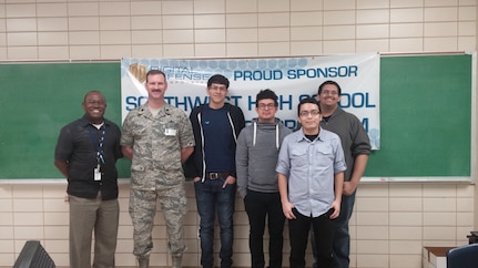 Lt. Col. Jim Burleigh, Cyber Mission Forces Planner for 24th Air Force, met with Mr. Arthur Celestin (left), coach of the Southwest High School CyberPatriot team, and team members from Southwest High School in San Antonio Jan. 15.  Southwest High School was one of 50 teams nationally to make the CyberPatriot semi finals.  (U.S. Air Force photo/2nd Lt. Meredith Hein)