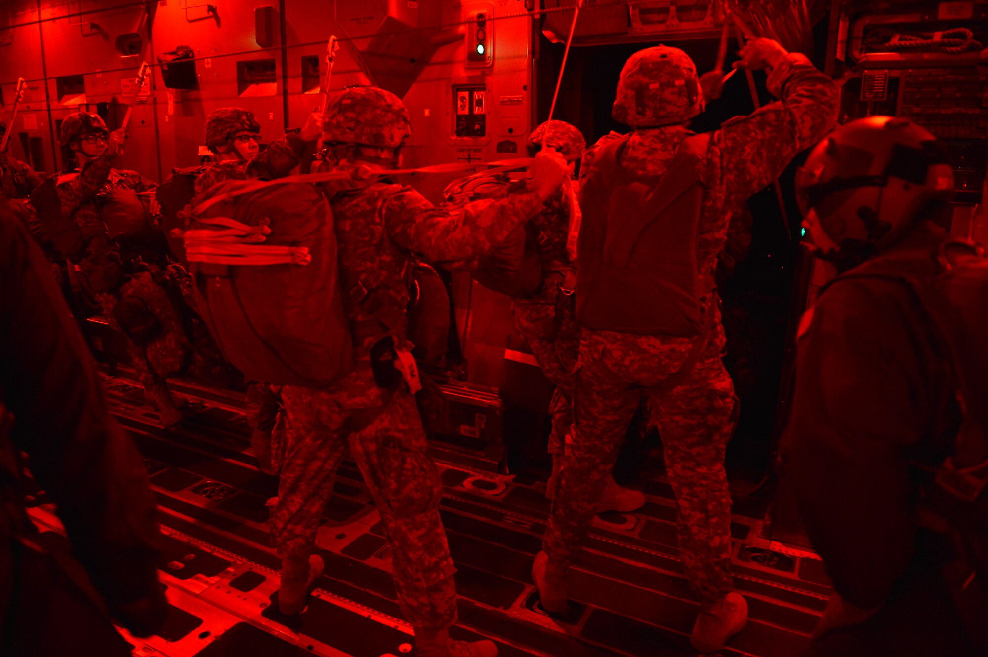 Paratroopers from the 82nd Airborne Division jump out of the door of a C-17 Globemaster III aircraft, Jan. 15, 2014, over Pope Army Air Field, N.C., during a joint forcible entry exercise. The exercise, part of Global Response Expeditor, brought more than 2,000 Soldiers and Airmen together to hone their skills at joint-integrated combat airdrop. (U.S. Air Force photo/Staff Sgt. Jason Truskowski)
