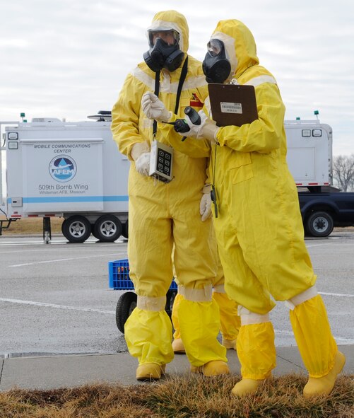 Senior Airman Raymond Reidenbach, and Staff Sgt. Rebecca Buhrman, 509th Civil Engineer Squadron emergency management support team members, conduct part of a three-legged survey team exercise in which they looked for potential areas of radioactive contamination during an inspection at Whiteman Air Force Base, Mo., Jan. 11, 2014. (U.S. Air Force photo by Staff Sgt. Alexandra M. Boutte/Released)