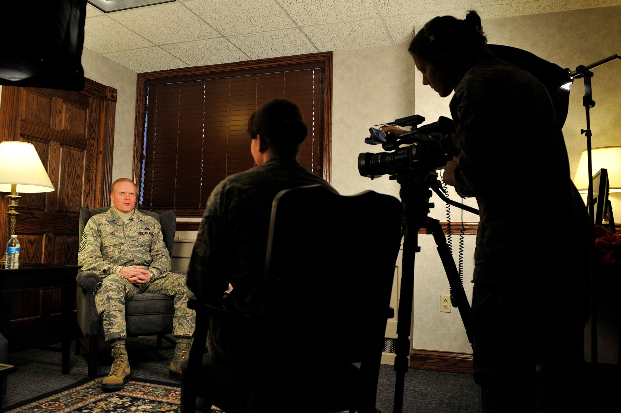 Chief Master Sgt. of the Air Force James A. Cody is interviewed by Airman 1st Class Megan Friedl (center), while Airman 1st Class Nina Orlando films, Jan. 17, 2014, at Scott Air Force Base, Ill. Cody discussed his experience visiting the base, what he hoped to emphasize to the Airmen while there and the challenges facing the Air Force. Friedl and Megan are both members of the 375th Air Mobility Wing public affairs office. (U.S. Air Force photo/Staff Sgt. Jonathan Fowler)