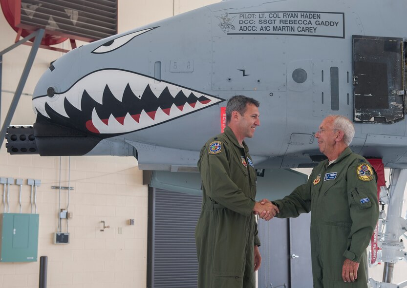 U.S. Air Force Lt. Col. Ryan Haden, left, 74th Fighter Squadron commander, shakes hands with his father, retired Col. Robert Haden, at Moody Air Force Base, Ga., Oct. 31, 2013. Ryan Haden followed in his father’s footsteps and also became an A-10C Thunderbolt II pilot. (U.S. Air Force photo by Airman 1st Class Alexis Millican/Released)