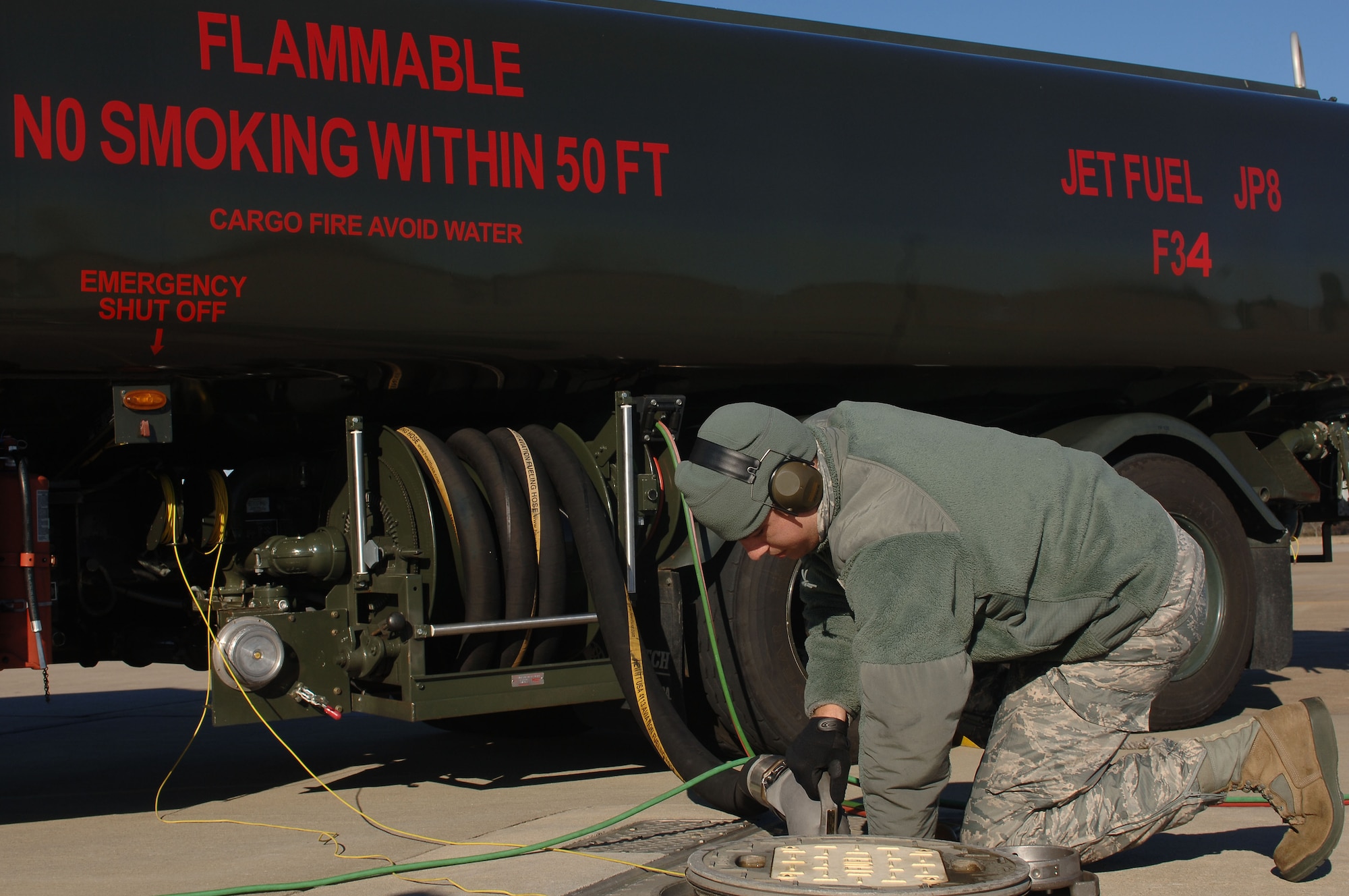 U.S. Air Force Staff Sgt. David Rinck, 633rd Logistics Readiness Squadron fuels distribution operator, connects hoses from a Hydrant Mobile Refueler to the underground hydrant system at Langley Air Force Base, Va., Dec. 13, 2013. The underground hydrant system allows fuel to be easily transported to the flightline. Rinck hails from Colora, Md. (U.S. Air Force photo by Senior Airman Teresa Aber/Released)