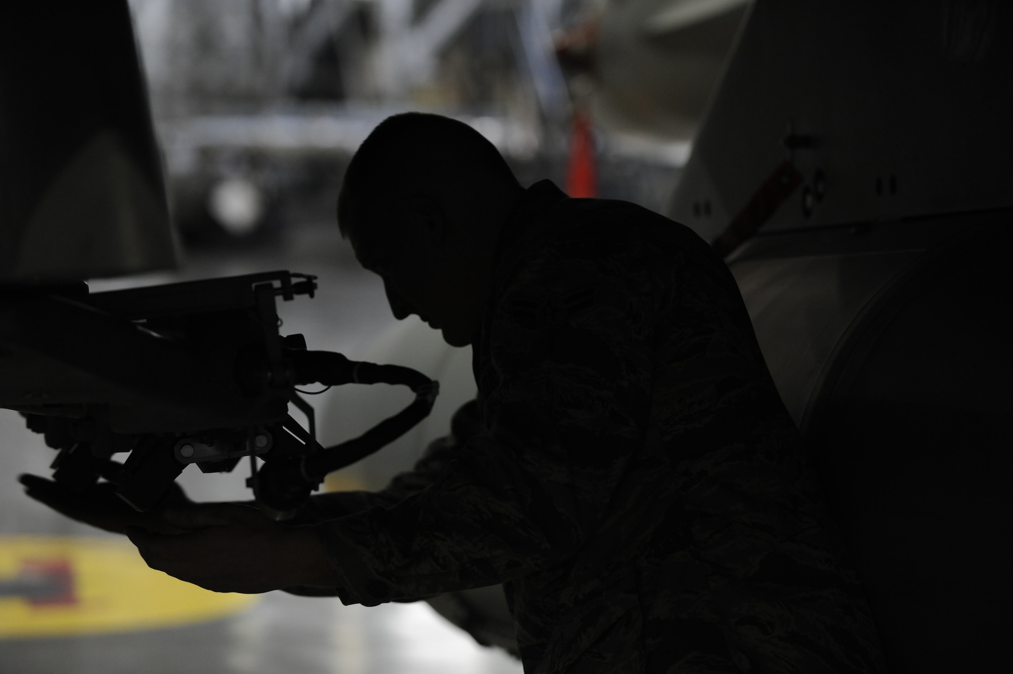 Airman 1st Class Michael Howell, 13th Aircraft Maintenance Unit, works on equipment during the Weapons Load Crew of the Year competition at Misawa Air Base, Japan, Jan. 17, 2014. The 13th's crew competed against the 14th AMU for a chance to represent Misawa at the Pacific Air Forces level competition. Weapons load crews were given 40 minutes to install the armaments and completed the task in 15 minutes 49 seconds. (U.S. Air Force photo/Airman 1st Class Patrick S. Ciccarone)
