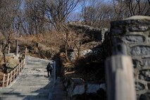 A traveler treks the pathways of Namsan Mountain Jan. 18, 2014, in Seoul, Republic of Korea. The paved walkways and stairs make Namsan Mountain an accessible and family friendly destination for locals and travelers alike. (U.S. Air Force photo by Staff Sgt. Jake Barreiro)