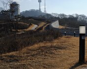 The Fortress Wall in Namsan Park leads to the top of Namsan Mountain and N Seoul Tower, as pictured here Jan. 18, 2014, in Seoul, Republic of Korea. Originally built around 1395, the Fortress Wall of Seoul served as a defense barreir for the Joseon dynasty. (U.S. Air Force photo by Staff Sgt. Jake Barreiro)