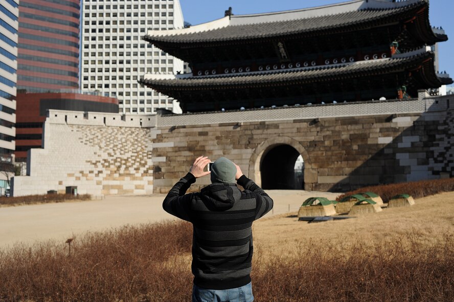A traveler takes a picture of the Namdaemun Sungnyemun Gate Jan. 18, 2014, in Seoul, Republic of Korea. The Sungnyemun Gate is an ancient structure originally built around 1395 and stands as one of the eight gates of the Fortress Wall of Seoul.(U.S. Air Force photo by Staff Sgt. Jake Barreiro)