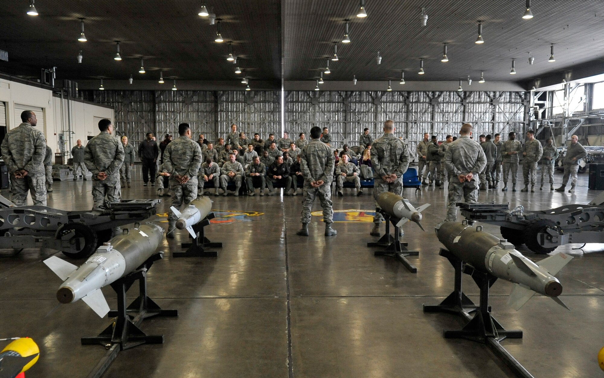 Airmen from the 13th and 14th Aircraft Maintenance Units await the start of the Weapons Load Crew of the Year competition at Misawa Air Base, Japan, Jan. 17, 2014. More than 50 spectators gathered to watch the load crews go head-to-head for a shot at being named Misawa’s weapons load crew of the year. The winner of the competition will be announced in March. (U.S. Air Force photo by Airman 1st Class Zachary Kee)