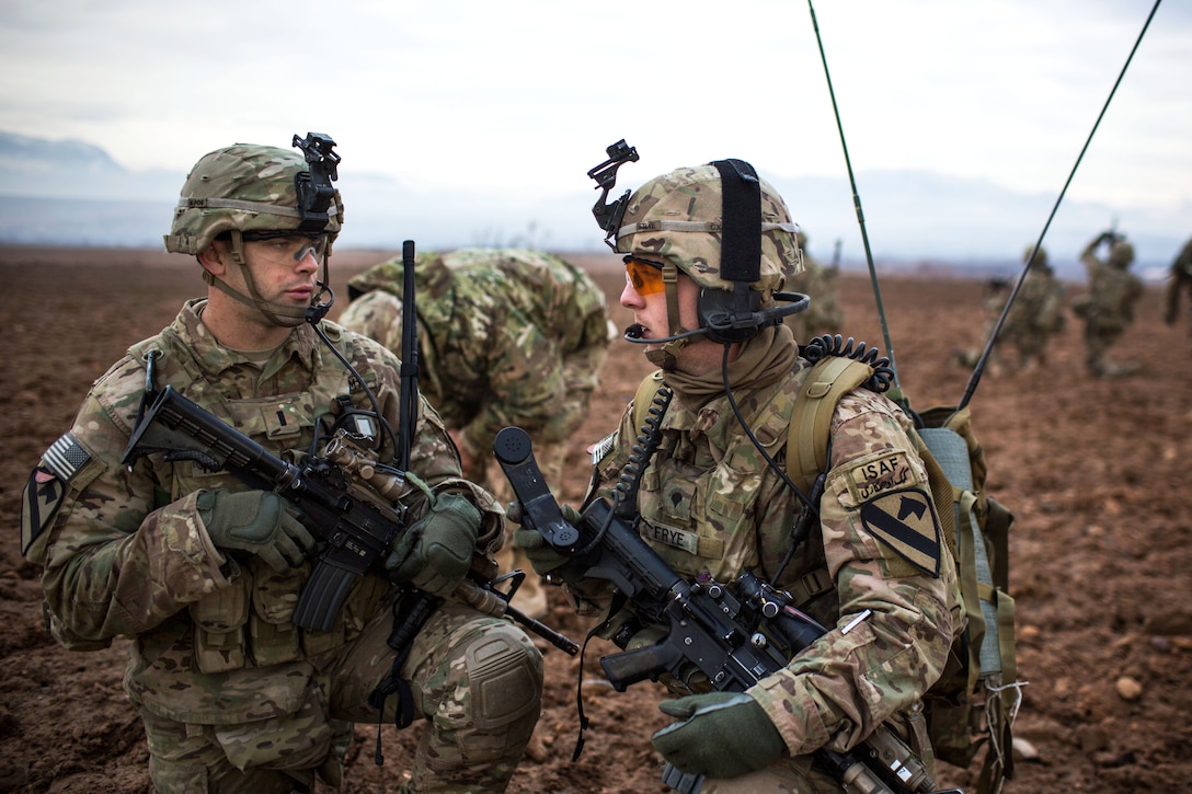 U.S. Army 1st Lt. Hoffman, left, talks to U.S. Army Spc. Sipple during ...