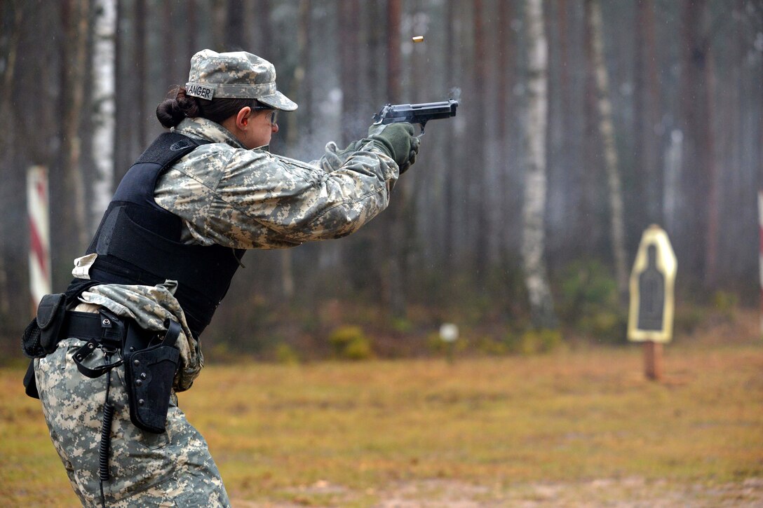 U.S. Army Pvt. Cori Berwanger fires her M9 pistol during a weapons qualification at the 7th Army Joint Multinational Training Command's Grafenwoehr Training Area, Germany, Jan. 13, 2014. Berwanger is assigned to the 615th Military Police Company, 18th Military Police Brigade.