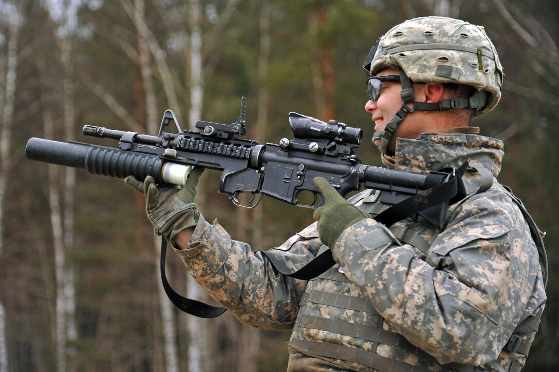 U.S. Army Sgt. Drew Garver loads a 40mm practice round into a M203 grenade launcher at the 7th Army Joint Multinational Training Command's Grafenwoehr Training Area, Germany, Jan. 16, 2014. Garver is assigned to the 615th Military Police Company, 18th Military Police Brigade.