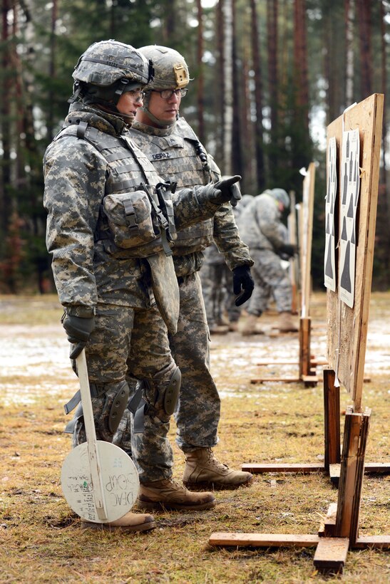 U.S. Army 1st Lt. Maria Steen, left, and U.S. Army Sgt. Jose Depaz review targets during a weapons qualification at the 7th Army Joint Multinational Training Command's Grafenwoehr Training Area, Germany, Jan. 16, 2014. Steen and Depaz are assigned to the 615th Military Police Company, 18th Military Police Brigade.