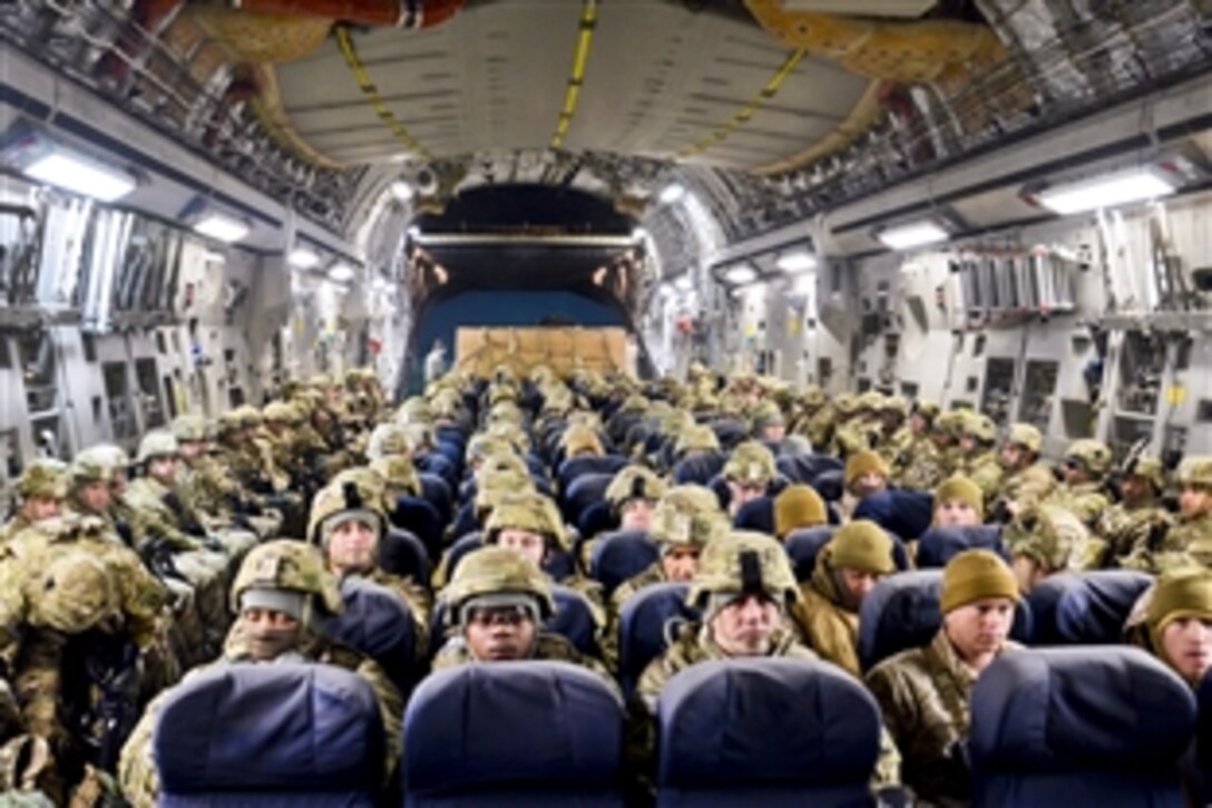 U.S. soldiers sit inside a C-130 aircraft before take off from Manas Air Base, Kyrgyzstan, Jan. 7, 2014. The soldiers are assigned to the 101st Airborne Division's 159th Combat Aviation Brigade. The soldiers flew to Bagram Airfield on the last leg of their trip from Fort Campbell, Ky.