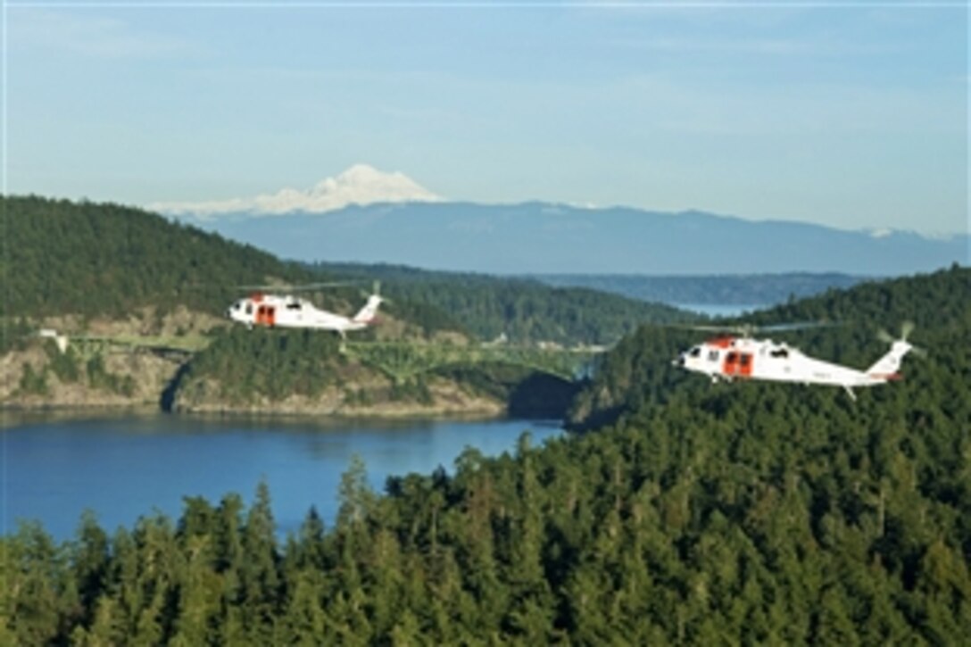 Two MH-60 Seahawk helicopters fly in formation during a training operation in the Pacific Northwest in Oak Harbor, Wash., Jan. 16, 2014. The Naval Air Station Whidbey Island Search and Rescue team provides assistance to military and civilian personnel throughout the Pacific Northwest. 