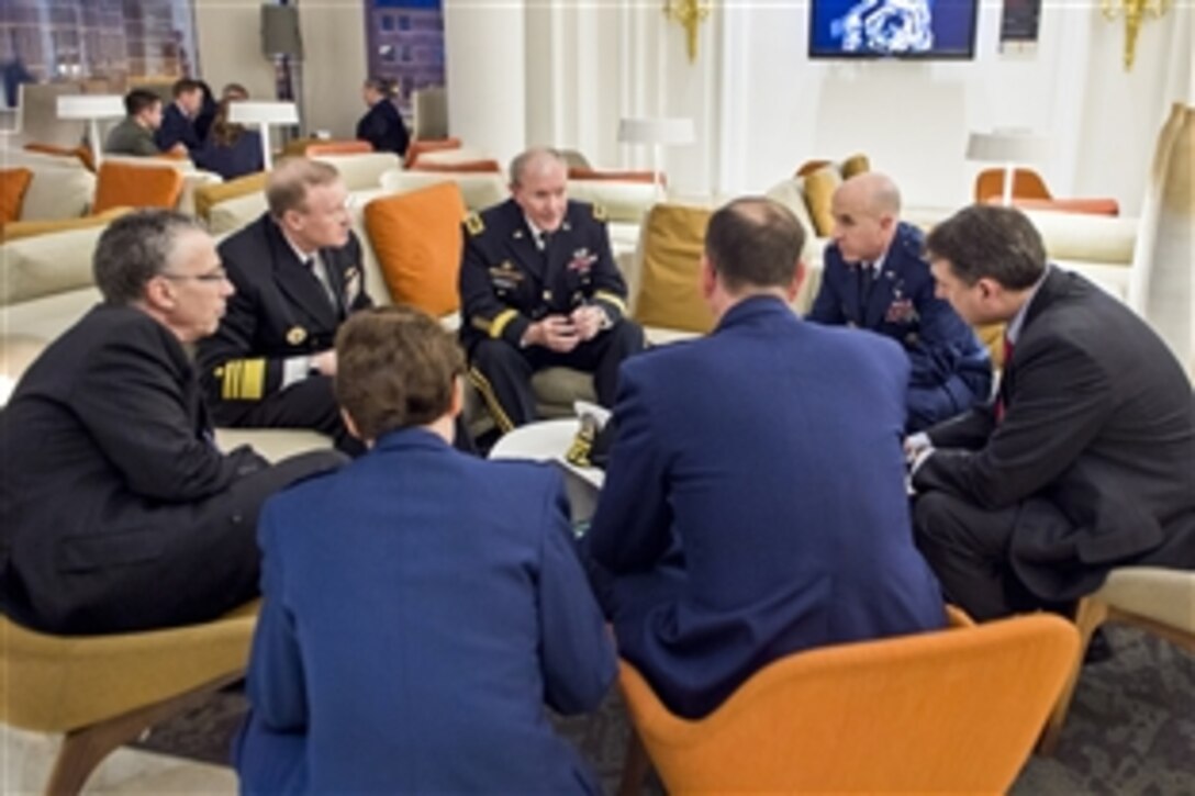 U.S. Army Gen. Martin E. Dempsey, back center, chairman of the Joint Chiefs of Staff, speaks with members of his staff in Brussels, Jan. 21, 2014. Dempsey is on a three-day trip during which he is scheduled to meet with his NATO and Russian counterparts.