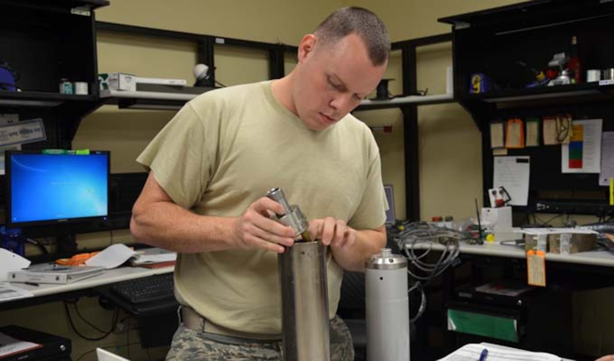 Staff Sgt. Tobee Jefferson, a geophysical maintenance supervisor with the Air Force Technical Applications Center, Patrick AFB, Fla., installs a high-grade, stainless steel instrument head into a 23900 seismometer. (U.S. Air Force photo/Susan A. Romano)