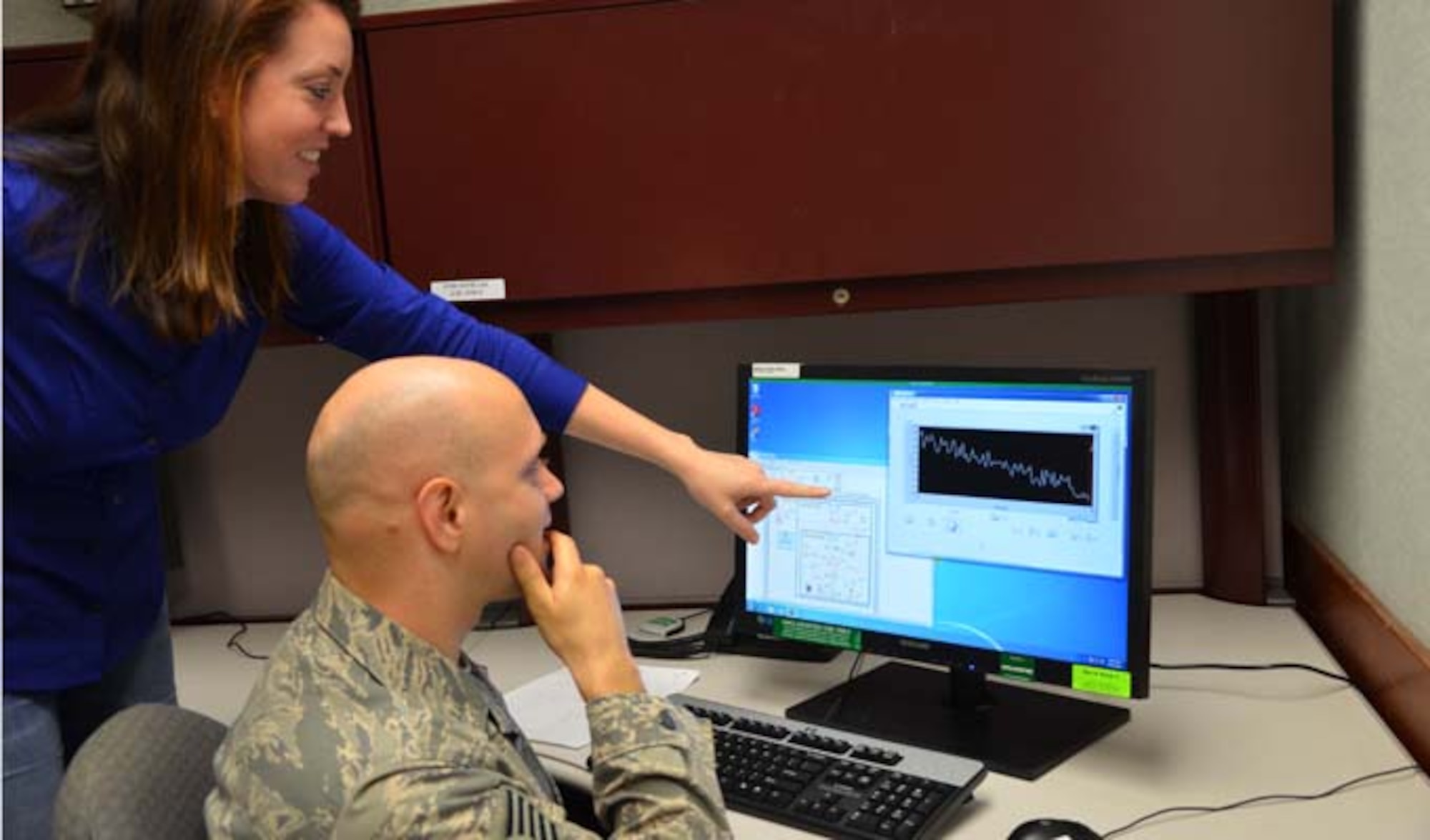 Dr. Theresa Hofstetter and Tech. Sgt. Daniel McAllister review coded algorithms at one of two stand-alone computer terminals that are capable of simulating the Air Force Technical Applications Center's custom thermal ionization mass spectrometers at Patrick AFB, Fla. Hofstetter is a  a mass spectrometry scientist and McAllister is an exercise and evaluations NCO in charge. The duo is part of AFTAC's Innovation Lab, a concept dedicated to developing technologies at a lower cost to reduce operations maintenance and overhead. (U.S. Air Force photo/Susan A. Romano)
