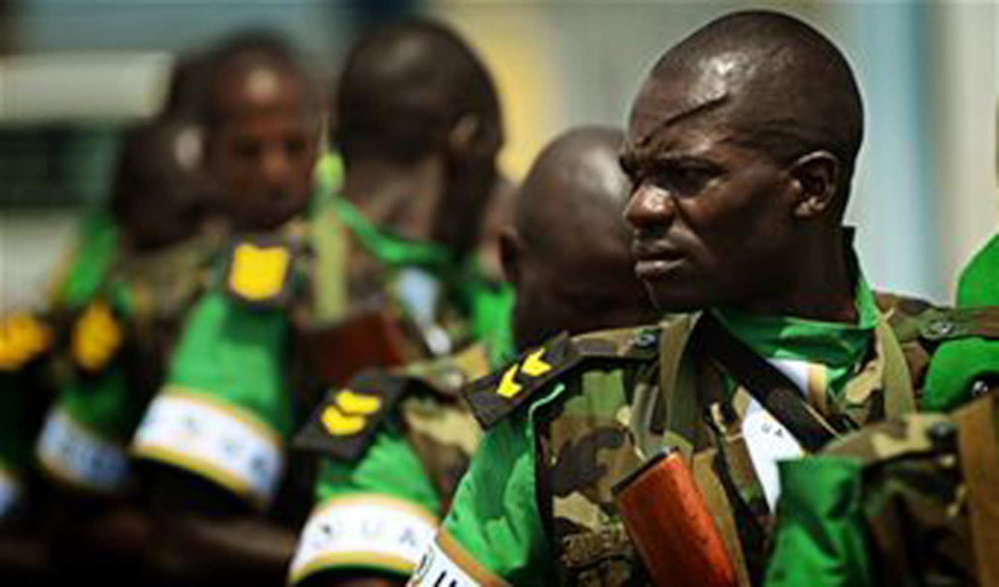 Rwandan soldiers wait in line at the Kigali airport Jan. 19, 2014, to get on a C-17 Globemaster III, based out of McChord Air Force Base, Wash. U.S. forces will transport a total number of 850 Rwandan soldiers and more than 1,000 tons of equipment into the Central African Republic to aid French and African Union operations against militants during this three-week operation. (U.S. Air Force photo/Staff Sgt. Ryan Crane)