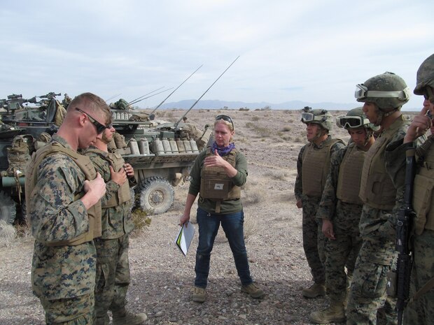 Rebecca Jaworski, a Marine Corps Systems Command biomedical engineer, explains fit and function of the fighting jacket variant of the modular scalable vest to the Marines of 1st Light Armored Reconnaissance battalion. Jaworski and fellow MCSC employee Mackie Jordan, an engineer (not pictured), spent several days embedded with the Marines of the 1st LAR during field exercises this November.