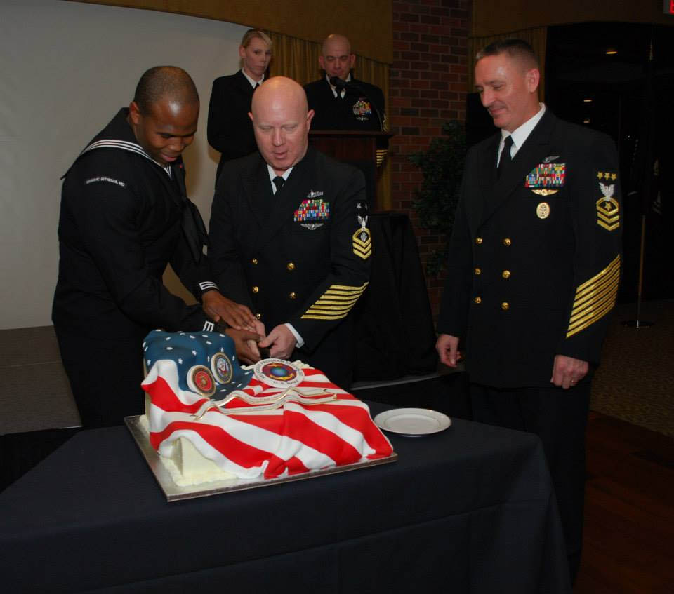 The youngest and eldest sailor in the religious program specialist rating cut a cake under the supervision of Master Chief Petty Officer of the Navy Michael Stevens at Harbor View in Woodbridge, Va., on Jan. 16, 2014. Stevens, the senior enlisted leader of the Navy, was the guest speaker at the event.