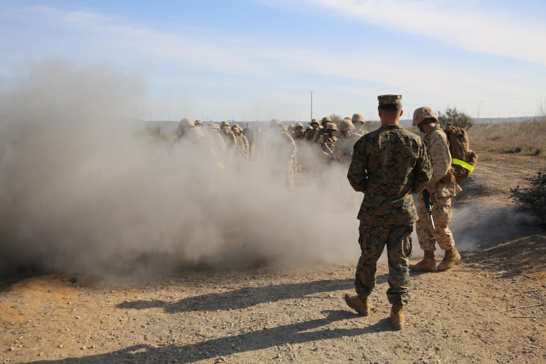 Recruits of Company K, 3rd Recruit Training Battalion, react to a simulated Improvised Explosive Device blast at the IED Lane at Edson Range, Jan. 8. Recruits are trained in the early stages of their Marine Corps careers on how to search and react to an IED device.
