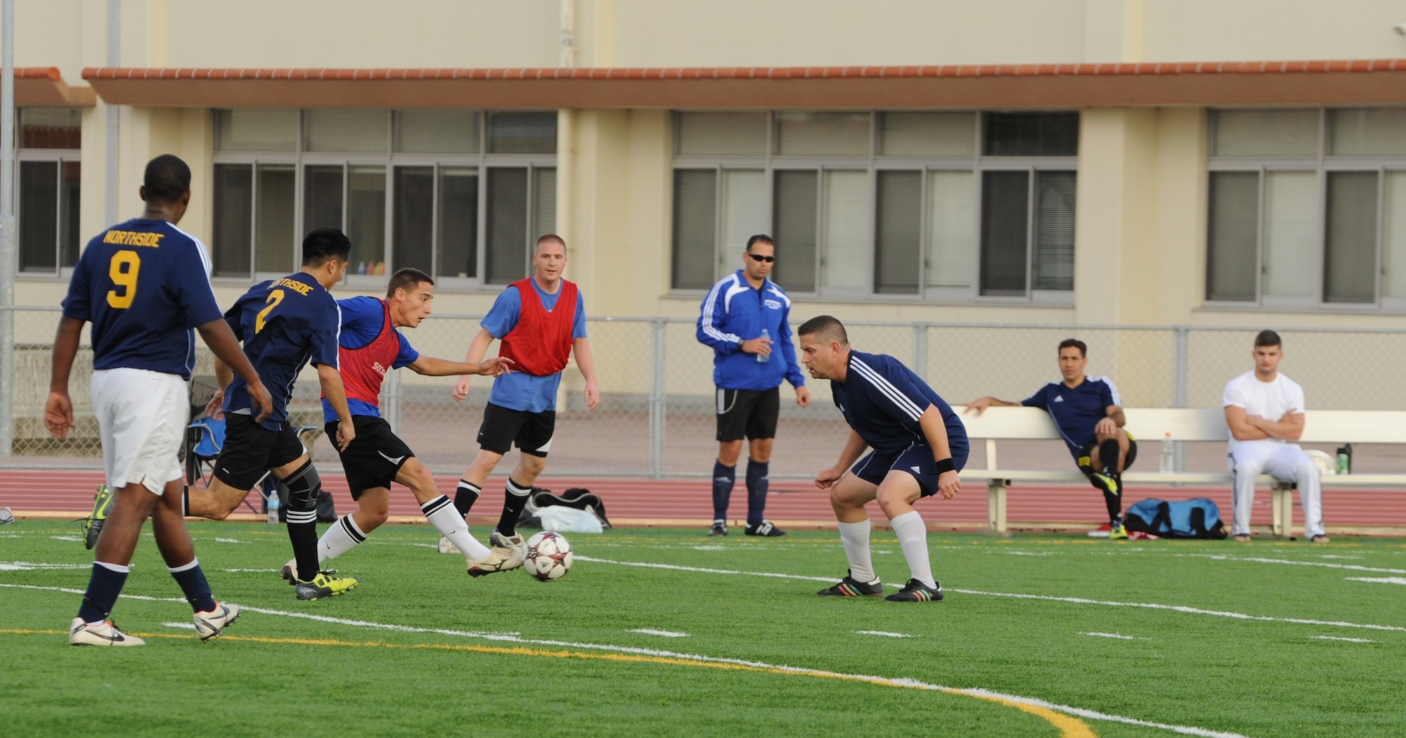 U.S. Air Force Master Sgt. Jody Miller, 718th Aircraft Maintenance Squadron assistant superintendent, defends against the opposing team during an intramural soccer playoff game on Kadena Air Base, Japan, Jan. 12, 2014. Miller and other members created the 2013 soccer intramural season after being informed of its cancellation. (U.S. Air Force photo by Airman 1st Class Keith James)