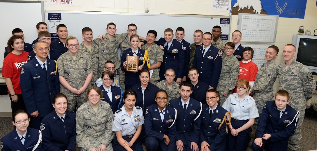 First Sergeants from Ellsworth Air Force Base, S.D., presented a plaque to members of the South Dakota 61st Air Force Junior Reserve Officer Training Corps for their involvement in the Gifts from the Heart program during an event at Douglas High School at Box Elder, S.D., Jan. 13, 2014. (U.S. Air Force Photo by Airman 1st Class Rebecca Imwalle /Released)