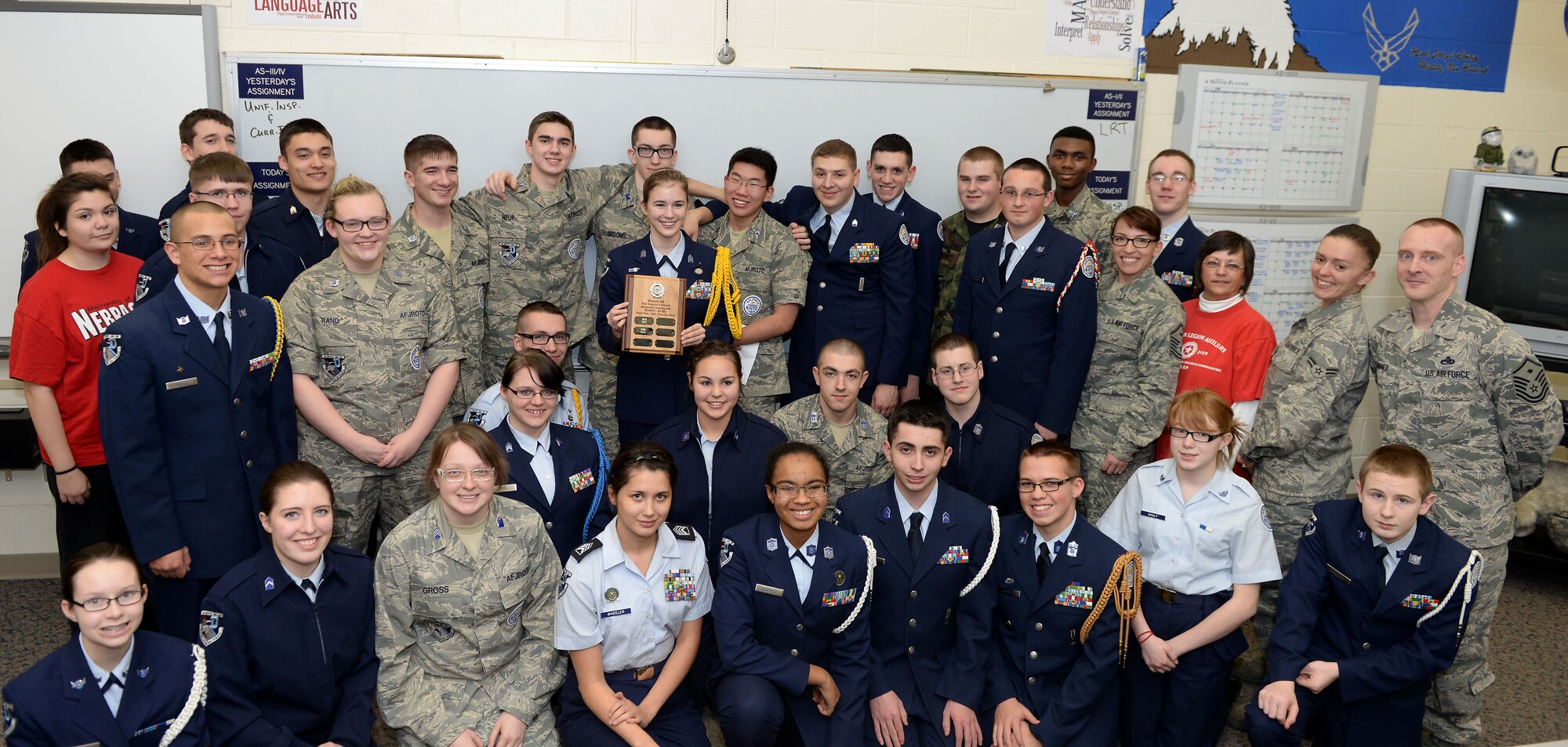 First Sergeants from Ellsworth Air Force Base, S.D., presented a plaque to members of the South Dakota 61st Air Force Junior Reserve Officer Training Corps for their involvement in the Gifts from the Heart program during an event at Douglas High School at Box Elder, S.D., Jan. 13, 2014. (U.S. Air Force Photo by Airman 1st Class Rebecca Imwalle /Released)