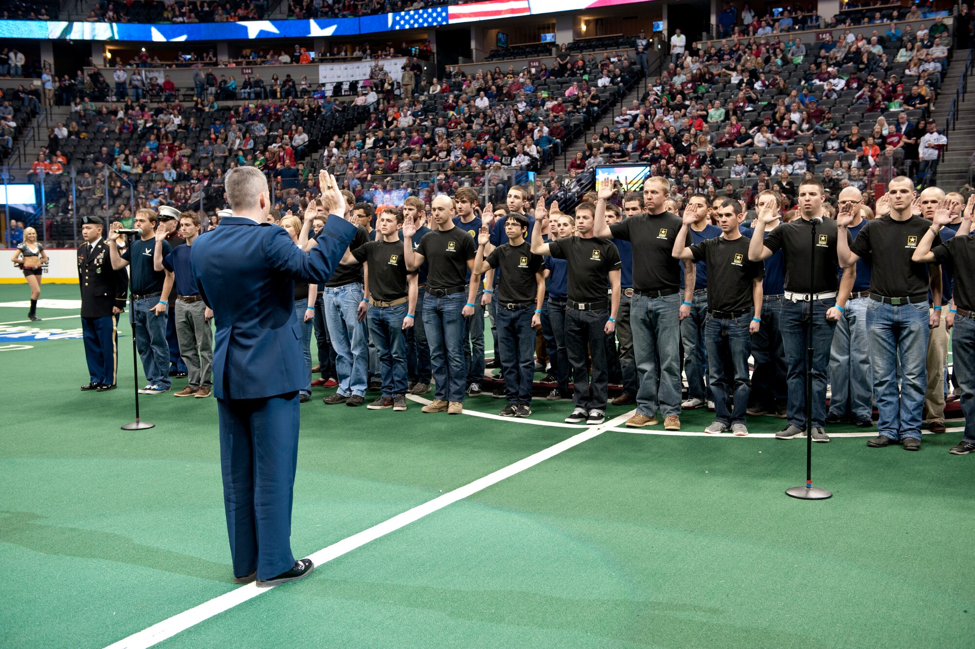 Lt. Col. Darrel Smith, 467th Recruiting Squadron commander, delivers the Oath of Enlistment to more than 60 military recruits during the Colorado Mammoth Lacrosse Military Appreciation Night halftime Jan. 18, 2014, at the Pepsi Center in Denver. The Air Force, Army, Marine, Navy and Coast Guard recruits recited the Oath of Enlistment, dedicating themselves to the service of their country in front of 17,000 lacrosse fans. (U.S. Air Force photo by Senior Airman Phillip Houk/Released)
