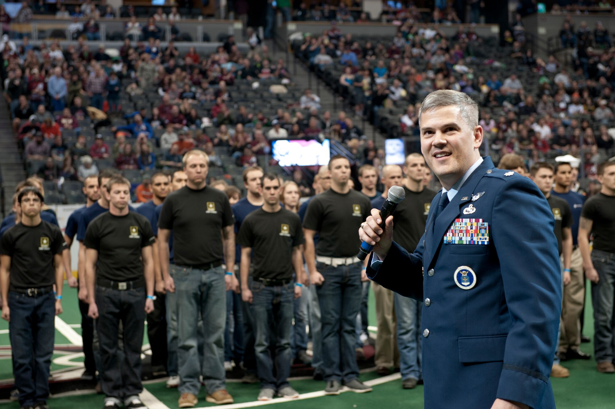 Lt. Col. Darrel Smith, 467th Recruiting Squadron commander, introduces the delayed entry program members before delivering the Oath of Enlistment during the Colorado Mammoth Lacrosse Military Appreciation Night halftime Jan. 18, 2014, at the Pepsi Center in Denver. More than 60 recruits recited the Oath of Enlistment, dedicating themselves to the service of their country in front of 17,000 lacrosse fans. (U.S. Air Force photo by Senior Airman Phillip Houk/Released)