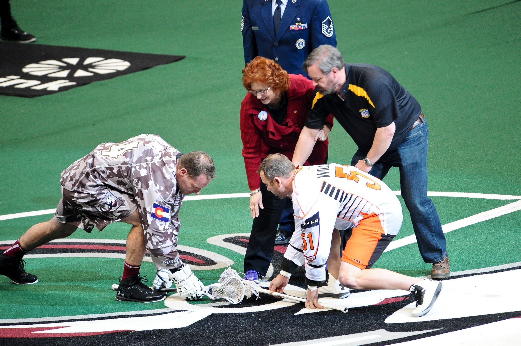 Patricia and Robert O’Kane-Trombley, the parents of Capt. Thomas O’Kane, drop the ball for the first face-off of the game during the Colorado Mammoth Lacrosse Military Appreciation Night Jan. 18, 2014, at the Pepsi Center in Denver. Captain O’Kane was an Air Force F-15 pilot who died with his co-pilot on July 18, 2009, in an air incident. O’Kane’s parents were honored for their son’s exceptional service during the annual Military Appreciation Night in which the Colorado Mammoths honored current, past and future service members. (U.S. Air Force photo by Senior Airman Phillip Houk/Released)