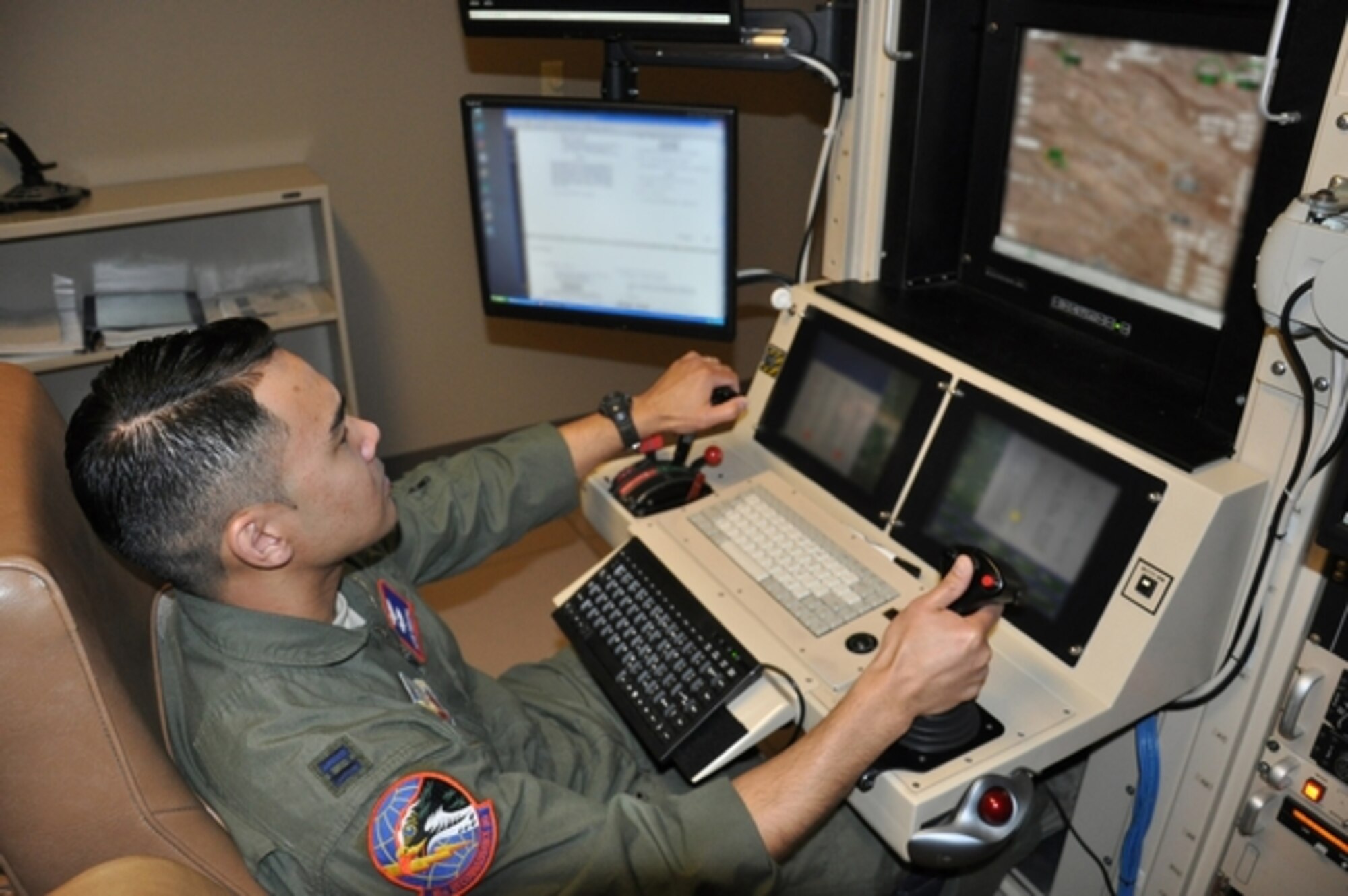 Capt. Adam trains on the MQ1-B Predator flight simulator Jan. 9 in Las Vegas. Adam has flown more than 300 combat hours since becoming the first Air National Guard graduate of the 18X MQ1 Predator remotely-piloted training course. (Photo edited for security reasons).  Photo by Maj. Dennis Fournier, Joint Force Headquarters Public Affairs.