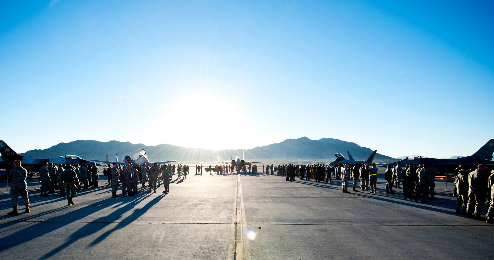 Nellis Air Force Base Airmen watch as weapons load crews from the 57th and 757th Aircraft Maintenance Squadrons compete in the annual weapons load crew competition on the flightline Jan. 17, 2014, at Nellis AFB, Nev. The load crew competitions ensure Airmen maintain their skills while also promoting competition and camaraderie among the squadrons. Load crew competitions are held four times a year in addition to an annual competition to determine the best load crew of the year. The winning team will be announced at the Maintenance Professional of the Year Banquet. (U.S. Air Force photo by Airman 1st Class Thomas Spangler) 