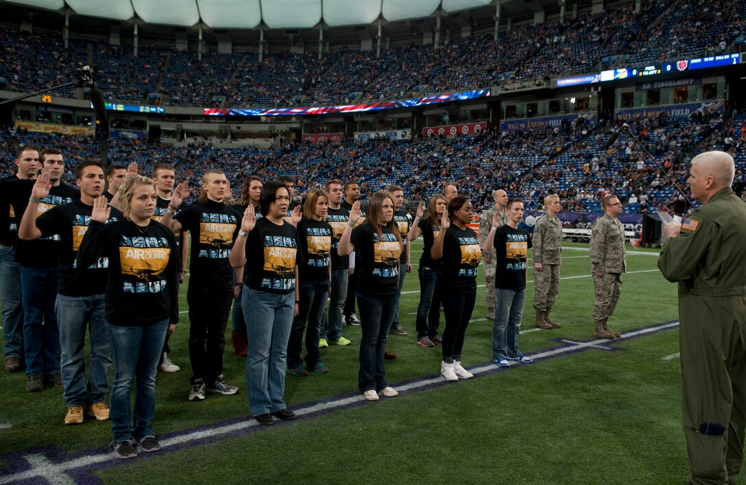 New recruits from the 133rd Airlift Wing recite the oath of enlistment before the Minnesota Vikings verses the Chicago Bears game at Mall America Field in Minneapolis, Minn., Dec. 1, 2013. Most of the Airmen will be leaving for basic military training where they will train and develop into the next generation of Airmen to serve in the world’s greatest Air Force.

 (U.S. Air National Guard photo by Tech. Sgt. Amy M. Lovgren/Released) 
