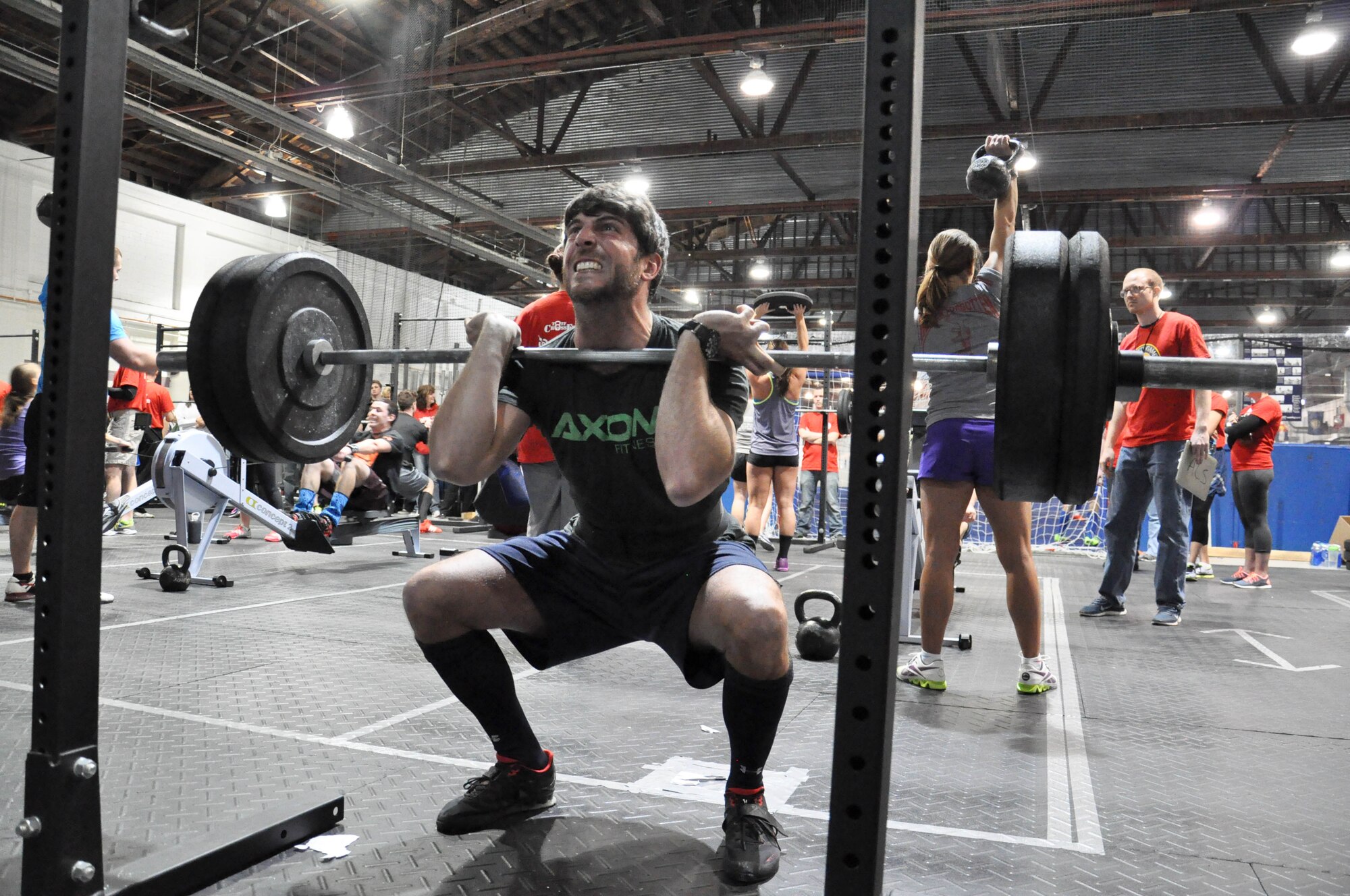 Team Offutt Tactical Fitness competitor Jason Sellers, U.S. Strategic Command, completes a front squat during the second of three workout of the 2014 TactFit Games at the Offutt Field House Jan. 19. The TactFit Games helps raise money for the TactFit program, which is a non-profit entity ran completely by volunteers. Each team pays a registration fee of $120, which will go toward coaching certifications for the TactFit program. (U.S. Air Force Photo by 2nd Lt. Carly A. Costello/Released)