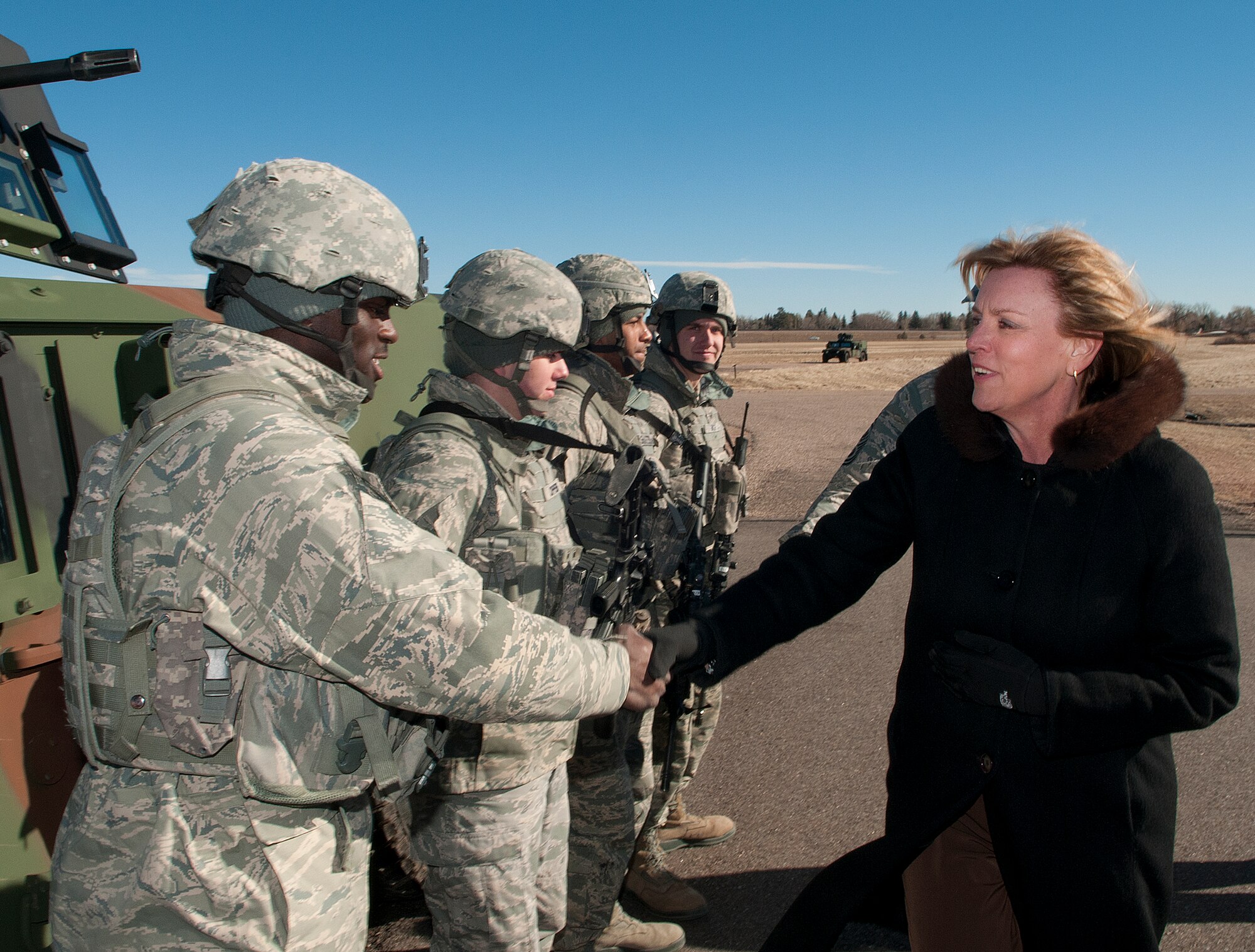 140121-F-JW079-203 Secretary of the Air Force Deborah Lee James shakes hands with Senior Airman Travis Lawton, 790th Missile Security Forces Squadron fire team member, Jan. 21, 2014. James visited the 20th Air Force and 90th Missile Wing on F.E. Warren Air Force Base, Wyo., to learn about the Minuteman III weapon system and the Airmen who operate, maintain, secure and support it. (U.S. Air Force photo by R.J. Oriez)