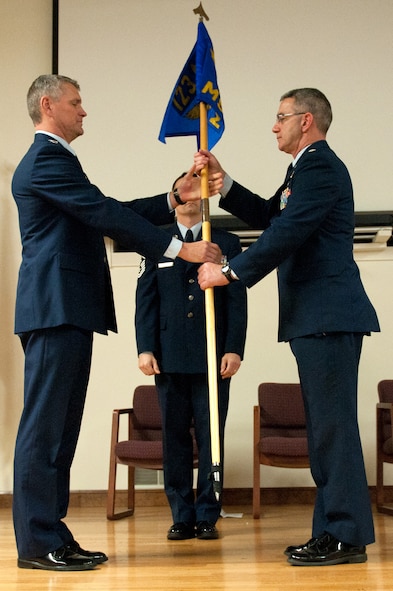 Lt. Col. Matt Stone (right) receives the guidon of the 123rd Mission Support Group from Col. Barry Gorter, commander of the 123rd Airlift Wing, during a change-of-command ceremony held at the Kentucky Air National Guard Base in Louisville, Ky., Jan. 11, 2014. As the group’s newest commander, Stone replaces Col. Jeffrey Peters, who is retiring from military service. (U.S. Air National Guard photo by Airman 1st Class Joshua Horton)