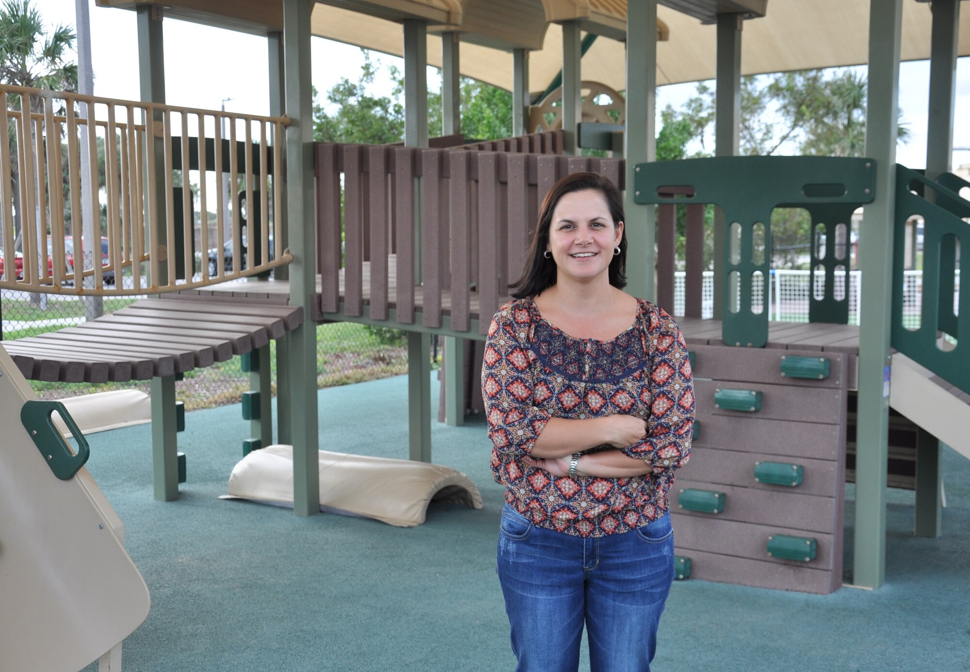 Tanya Trujillo, 45th Force Support Squadron family care coordinator, poses in front of the Child Development Center at Patrick Air Force Base, Fla. Dec. 13, 2013. “Being the family care coordinator is an incredibly rewarding experience,” said Trujillo. “You get to build a relationship with the children and see them grow and succeed.”