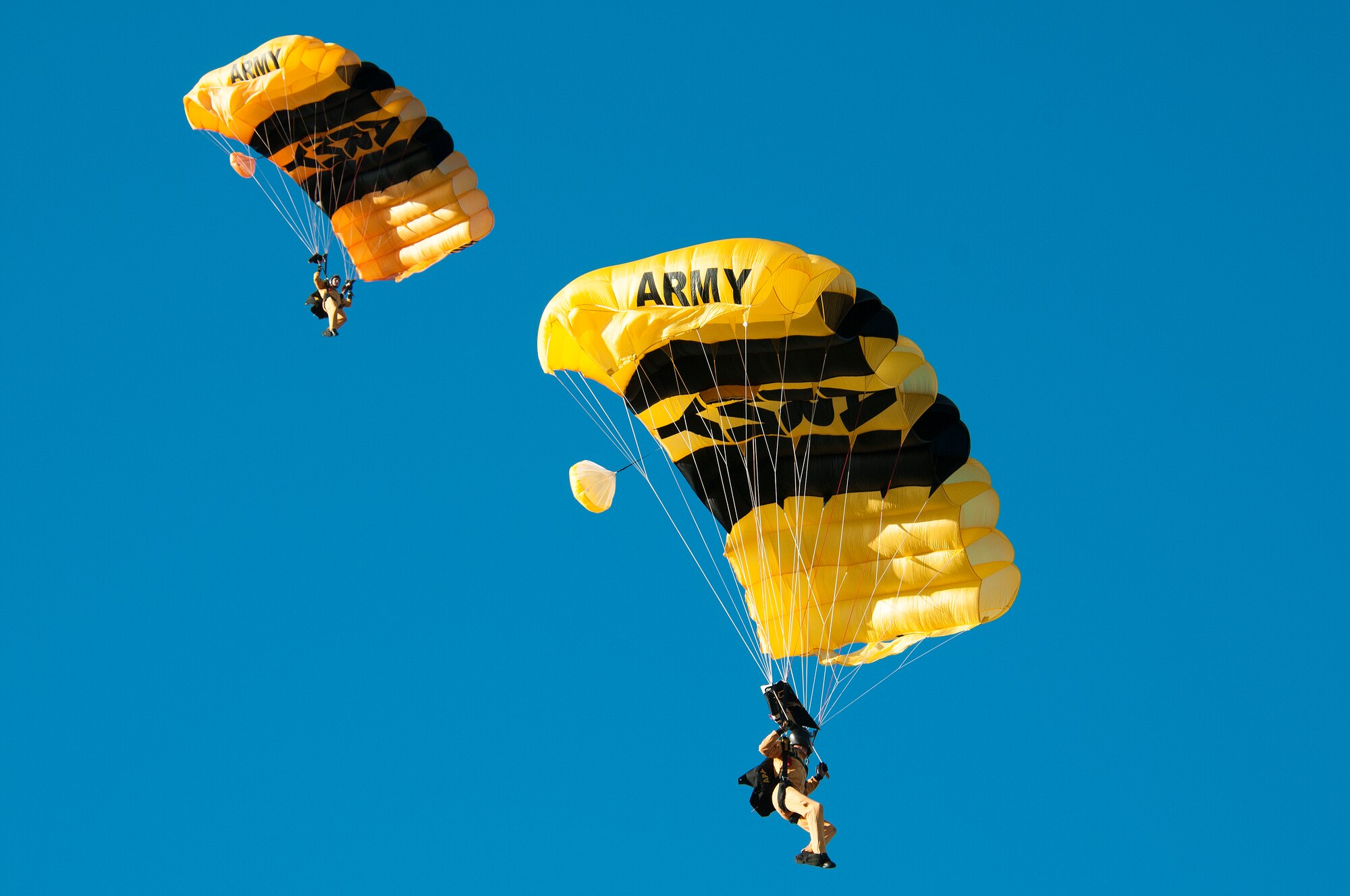 Two members of the U.S. Army parachute team, The Golden Knights, prepare to land at Homestead Air Reserve Base during their first day of training on Jan. 22.  The “Knights” are back at Homestead ARB for a fifth straight year conducting winter training.  Residents that live around the base will see the team's signature yellow and black parachutes until mid-March. (U.S. Air Force photo/Tim Norton)
