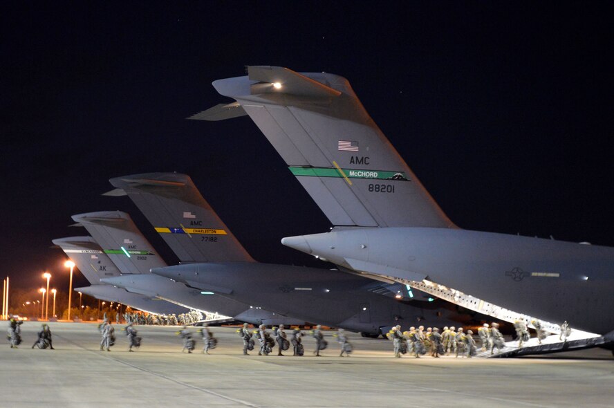 Army paratroopers from the 82nd Airborne Division load onto Air Force C-17 Globemaster III aircraft during joint exercise Global Response Expeditor on Jan. 15, 2014, at Pope Army Airfield, Fort Bragg, N.C. The purpose of this exercise was to prepare United States Transportation Command units, Air Mobility Command forces and elements of the XVIII Airborne Corps to respond as part of the Global Response Force and to conduct Joint Forcible Entry operations. This exercise executed Joint Forcible Entry operations in support of a combined Joint Task Force utilizing drop zones at the Joint Readiness Training Center, Fort Polk, La. Air mobility aircraft and crews airdropped approximately 1,124 paratroopers and offloaded more than 120 short tons of cargo. (U.S. Air Force photo/Marvin Krause)