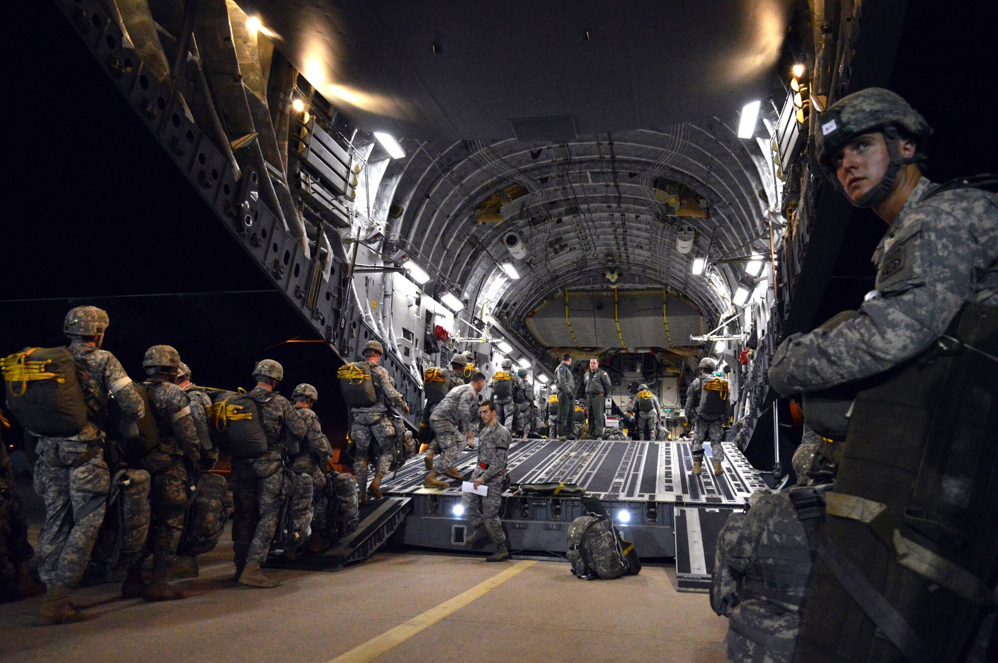 Army paratroopers from the 82nd Airborne Division load onto Air Force C-17 Globemaster III aircraft during joint exercise Global Response Expeditor on Jan. 15, 2014, at Pope Army Airfield, Fort Bragg, N.C. The purpose of this exercise was to prepare United States Transportation Command units, Air Mobility Command forces and elements of the XVIII Airborne Corps to respond as part of the Global Response Force and to conduct Joint Forcible Entry operations. This exercise executed Joint Forcible Entry operations in support of a combined Joint Task Force utilizing drop zones at the Joint Readiness Training Center, Fort Polk, La. Air mobility aircraft and crews airdropped approximately 1,124 paratroopers and offloaded more than 120 short tons of cargo. (U.S. Air Force photo/Marvin Krause)