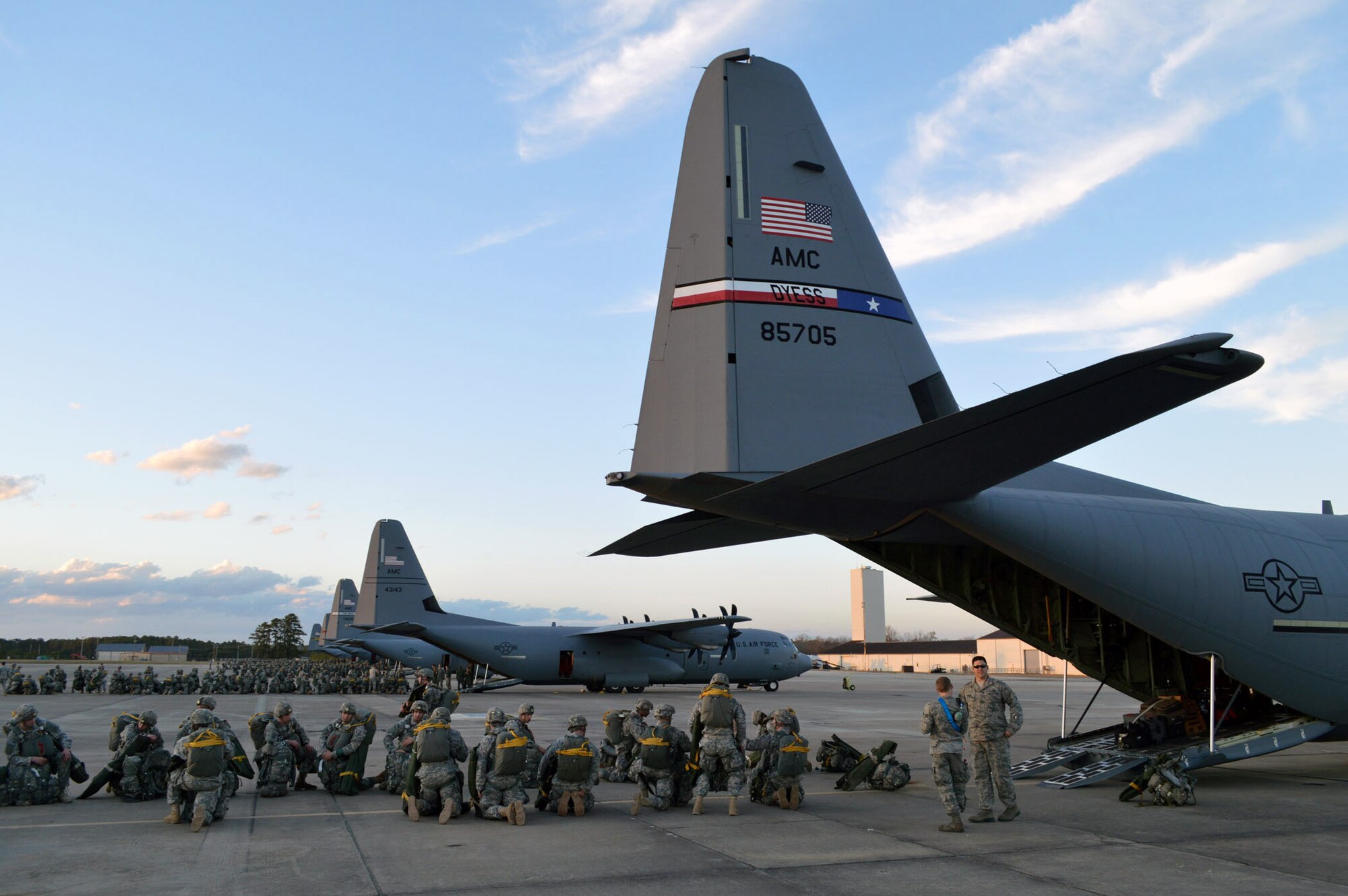 Army paratroopers from the 82nd Airborne Division prepare to load onto Air Force C-130 Hercules aircraft during joint exercise Global Response Expeditor on Jan. 15, 2014, at Pope Army Airfield, Fort Bragg, N.C. The purpose of this exercise was to prepare United States Transportation Command units, Air Mobility Command forces and elements of the XVIII Airborne Corps to respond as part of the Global Response Force and to conduct Joint Forcible Entry operations. This exercise executed Joint Forcible Entry operations in support of a combined Joint Task Force utilizing drop zones at the Joint Readiness Training Center, Fort Polk, La. Air mobility aircraft and crews airdropped approximately 1,124 paratroopers and offloaded more than 120 short tons of cargo. (U.S. Air Force photo/Marvin Krause)