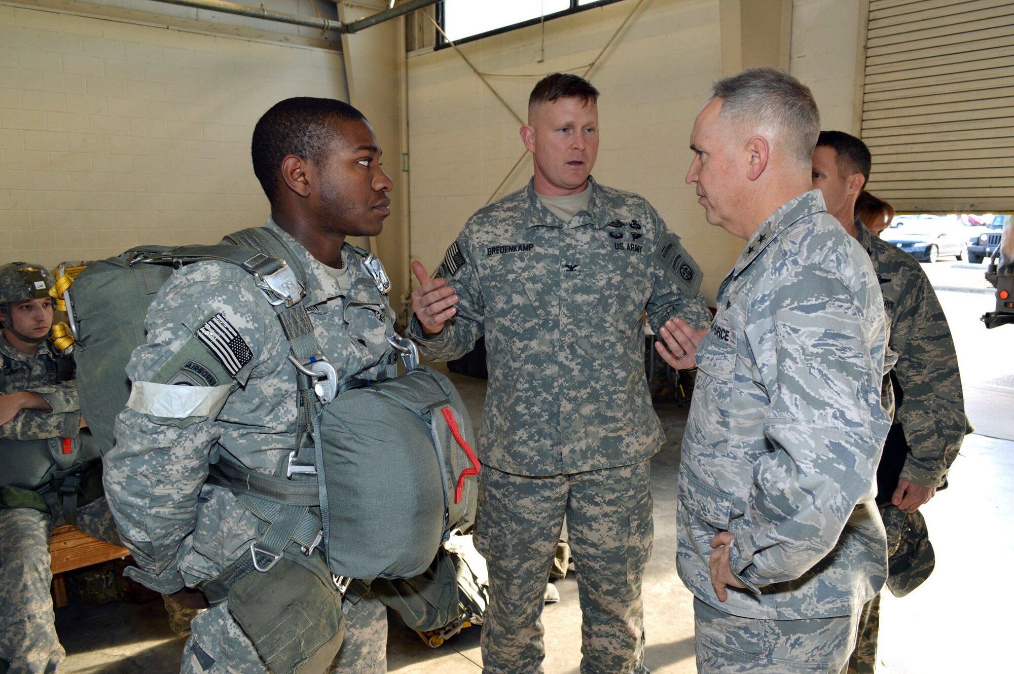 Army Col. Trevor Bredenkamp, 1st Brigade Combat Team commander, Fort Bragg, N.C., briefs Air Force Maj. Gen. Rick Martin, U.S. Air Force Expeditionary Center commander, about paratrooper techniques, tactics and procedures during joint exercise Global Response Expeditor on Jan. 15, 2014, at Pope Army Airfield, Fort Bragg, N.C. The purpose of this exercise was to prepare United States Transportation Command units, Air Mobility Command forces and elements of the XVIII Airborne Corps to respond as part of the Global Response Force and to conduct Joint Forcible Entry operations. This exercise executed Joint Forcible Entry operations in support of a combined Joint Task Force utilizing drop zones at the Joint Readiness Training Center, Fort Polk, La. Air mobility aircraft and crews airdropped approximately 1,124 paratroopers and offloaded more than 120 short tons of cargo. (U.S. Air Force photo/Marvin Krause)

