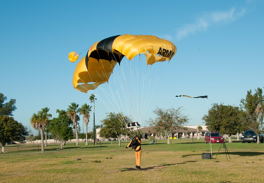A member of the U.S. Army parachute team, The Golden Knights, makes a perfect landing at Homestead Air Reserve Base during their first day of training on Jan. 22.  The “Knights” are back at Homestead ARB for a fifth straight year conducting winter training.  Residents that live around the base will see the team's signature yellow and black parachutes until mid-March. (U.S. Air Force photo/Tim Norton)