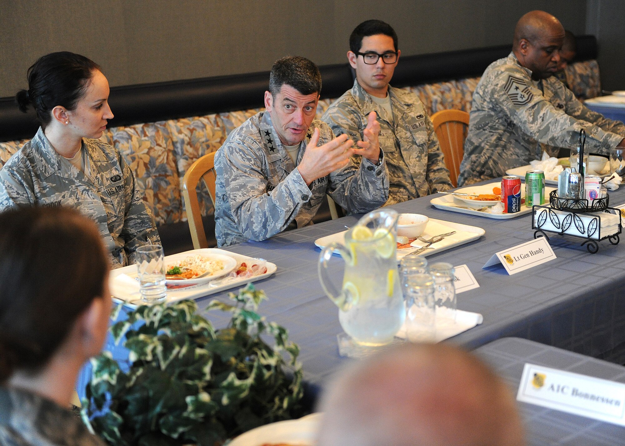 Lt. Gen. Russell Handy, 11th Air Force commander, shares lunch with 15th Wing Airmen at the Hale Aina Dining Facility during a familiarization tour of Joint Base Pearl Harbor-Hickam, Hawaii, Jan. 21, 2014. Handy thanked the Airmen for their continued service and dedication, and addressed issues concerning them and their families. (U.S. Air Force photo/Master Sgt. Jerome S. Tayborn)