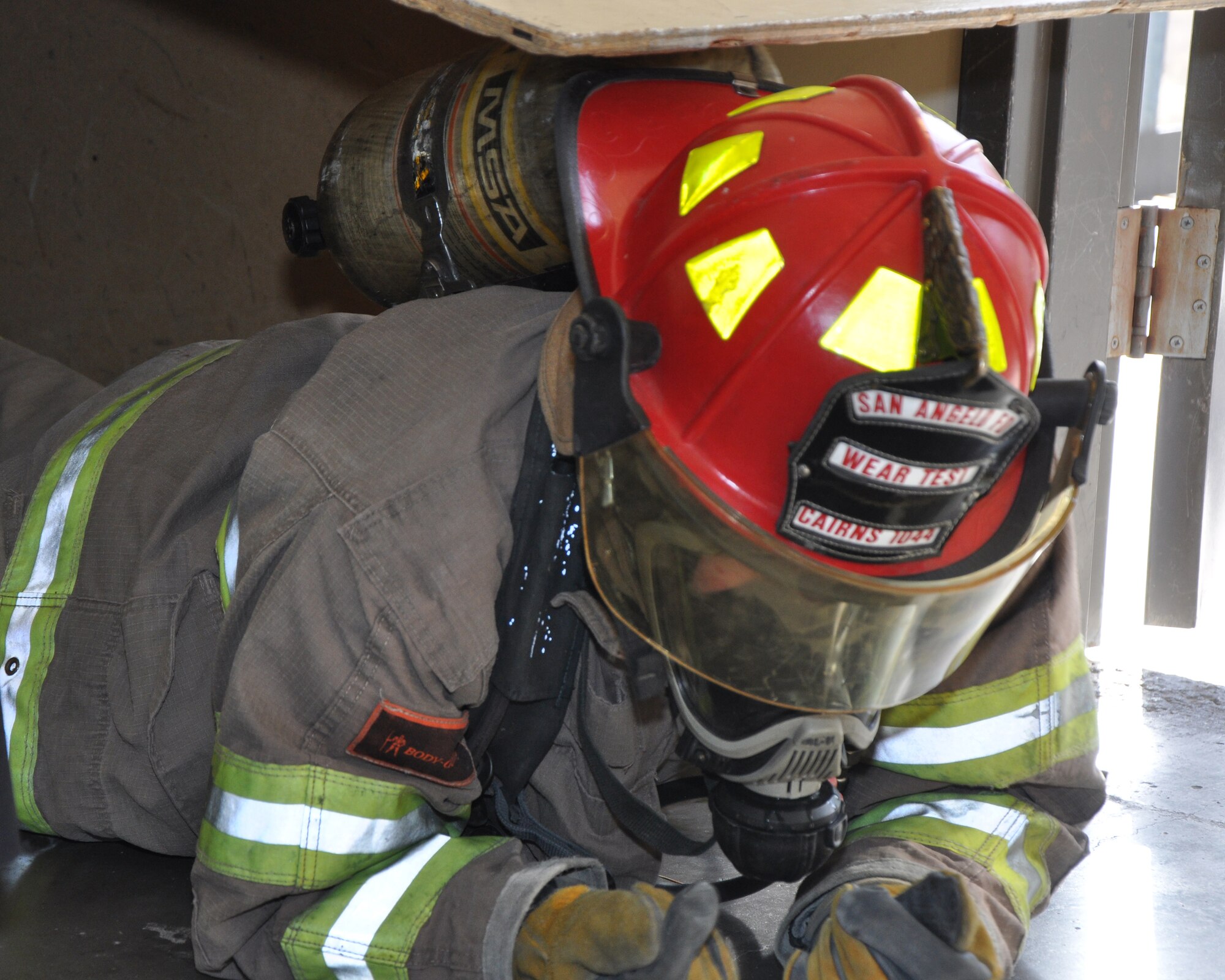 GOODFELLOW AIR FORCE BASE, Texas – A San Angelo Fire Department recruit completes the attic confined space simulator at the Louis F. Garland DoD Fire Academy Jan. 17. Goodfellow Air Force Base and SAFD use the completion of this course as a preliminary requirement before they move on to actual firefighting. (U.S. Air Force photo/ Senior Airman Joshua Edwards)