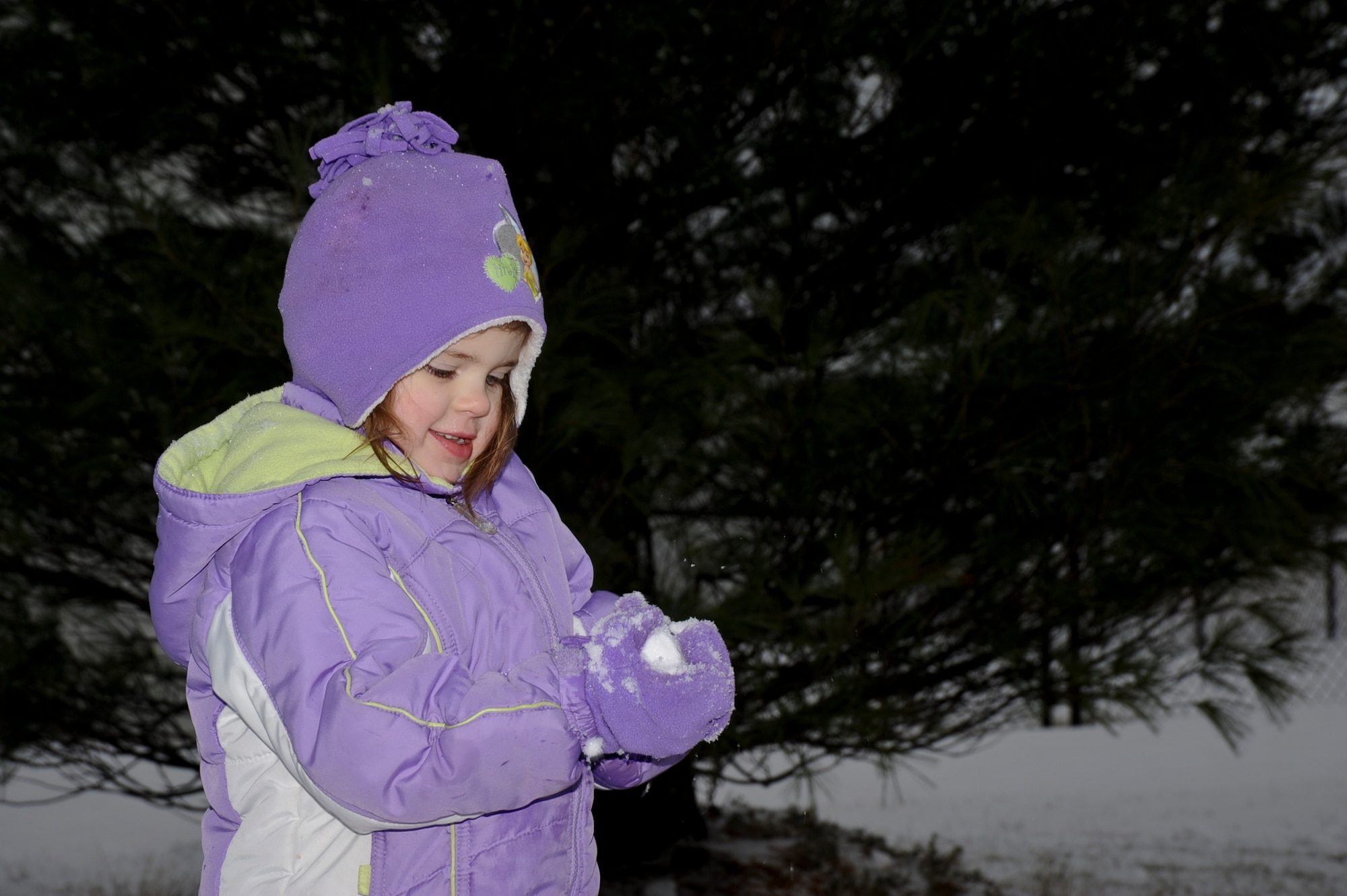 Gracie Singleton, 3, forms a snowball while playing in 10 inches of snow that fell Jan. 9, 2013 at Scott Air Force Base, Ill. School was canceled for almost a week when temperatures dropped below freezing and roads became hazardous. (U.S. Air Force photo by Airman 1st Class Sarah Hall-Kirchner/Released)