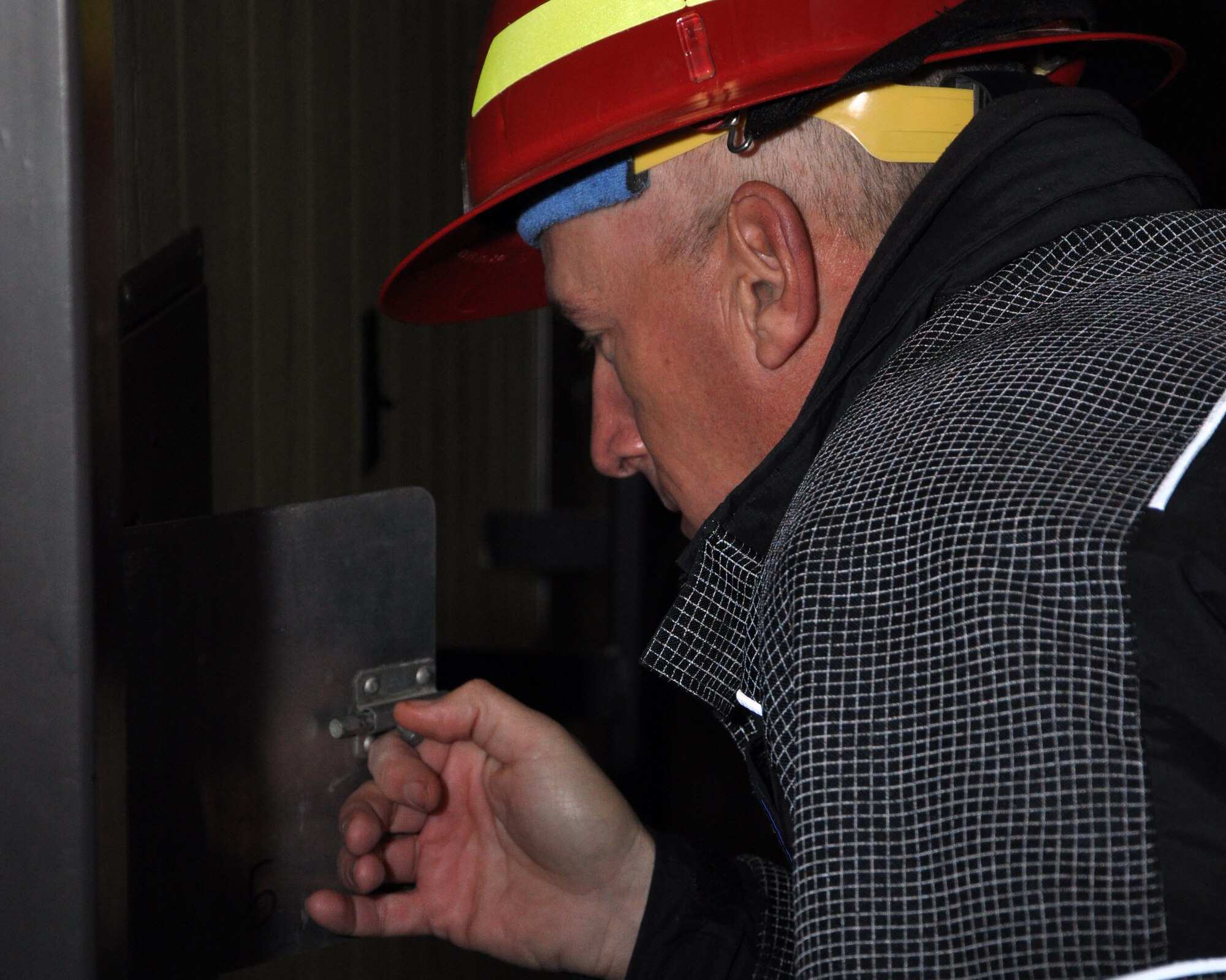 GOODFELLOW AIR FORCE BASE, Texas – Capt. Mark Hunt, San Angelo Fire Department Training Captain, opens a side hatch to check SAFD recruits inside a Louis F. Garland DoD Fire Academy confined space trainer Jan. 17. The trainer has various points along the course where instructors can open latches to monitor progression and give helpful information or open doors in case a trainee develops claustrophobia. (U.S. Air Force photo/ Senior Airman Joshua Edwards)