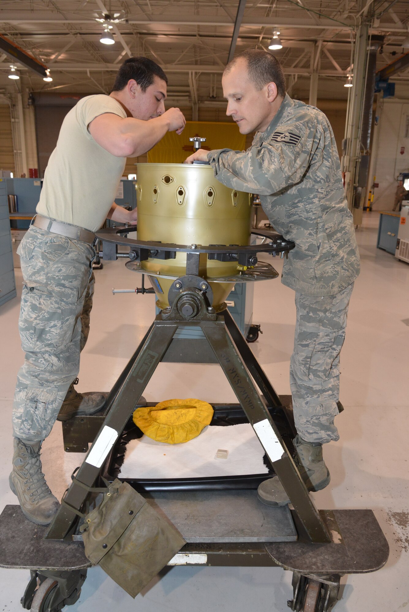 Airman 1st Class Daniel Talerico and Staff Sgt. Jesse McCrillis, 58th Maintenance Squadron's Propulsion Flight, install a compressor on a T400 engine.  The T400/T700 section works on the Pratt & Whitney T400 engine found in the UH-1N Huey helicopters and the General Electric T700 engine found in the HH-60 Pavehawk, and is the only unit in the Air Force that maintains the T400.  (Photo by Ken Moore)