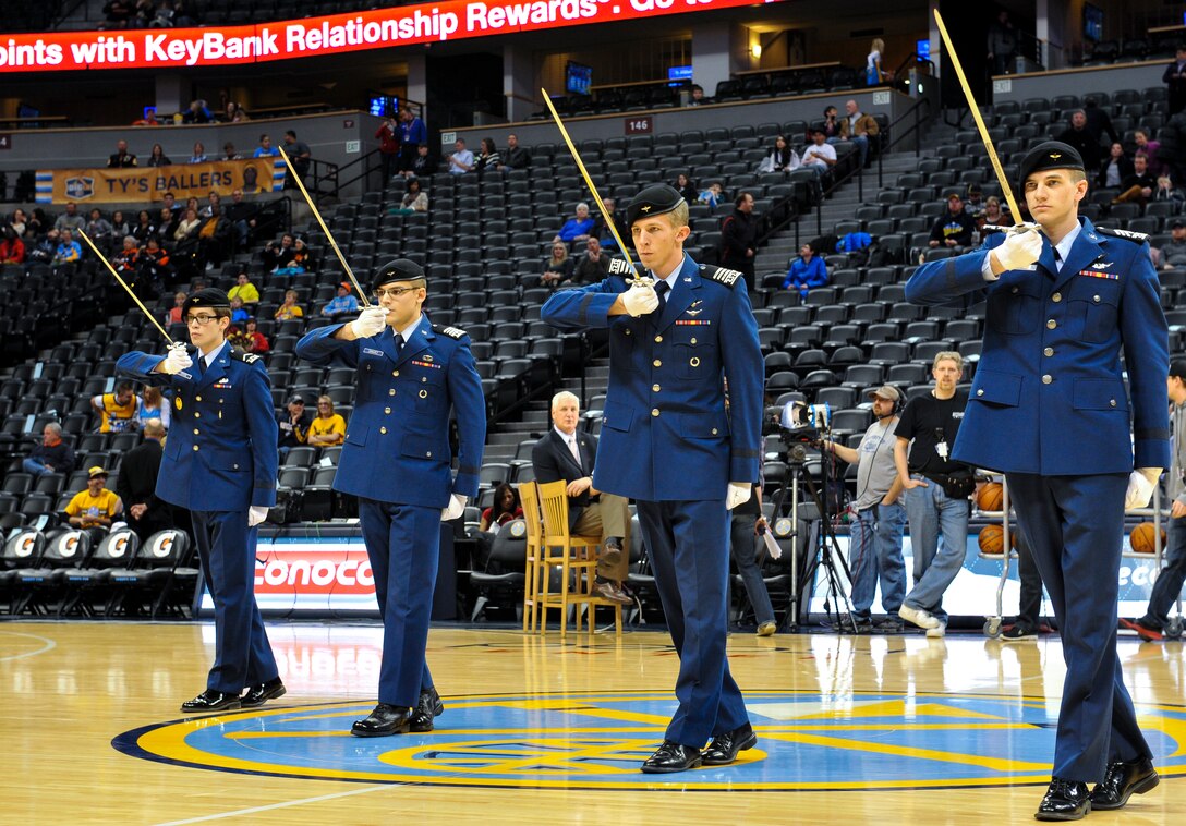 Four Air Force Academy cadets perform at the Denver Nuggets vs. Cleveland Cavaliers game Jan. 17, 2014, at the Pepsi Center in Denver. The Nuggets showed their appreciation for service members by honoring all military branches of service at the game. (U.S. Air Force photo by Airman 1st Class Samantha Saulsbury/Released)